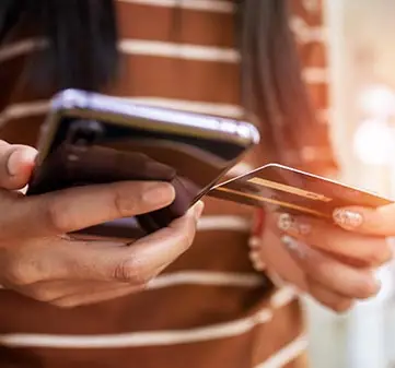 close up young woman hands holding credit card.