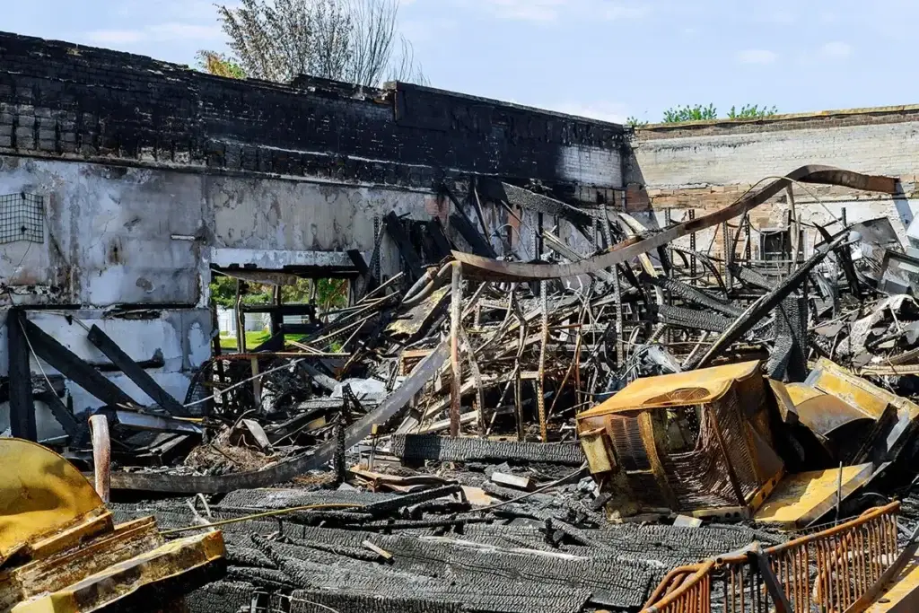 Burned and destroyed building after fire, symbolizing arson charges in Colorado property crime law.