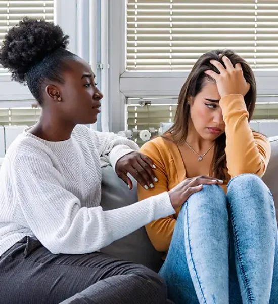 Friend comforting a distressed teenager; Lori Beck Law Office supports young people facing legal challenges in Denver, CO.