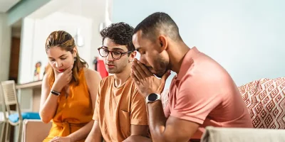 Group of young adults in serious discussion; Lori Beck Law Office addresses juvenile legal concerns and family matters in Denver, CO.