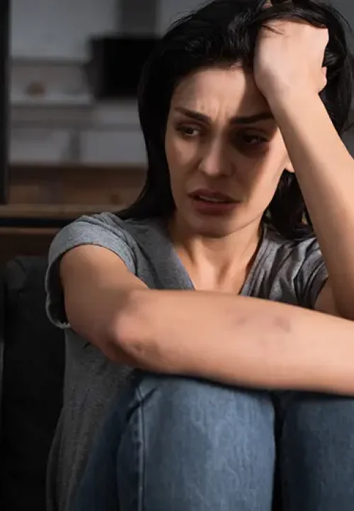 Distressed woman with bruise marks on her arm; Lori Beck Law Office assists domestic violence victims and defends against accusations in Denver, CO.