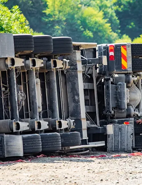 Overturned semi-truck with a distressed man nearby, symbolizing a severe truck accident; Lori Beck Law Office represents victims in Denver, CO.